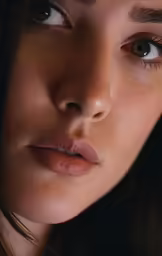 a woman with her hair in braids is staring straight ahead