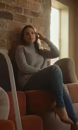 a beautiful young woman sitting on top of a couch