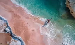 an aerial photo of a man standing on a wave pool