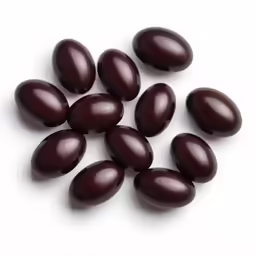 the dark colored beans are lined up in a pile
