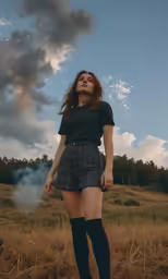 young woman standing in a field with tall brown hair