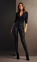 a woman with long hair in leather pants