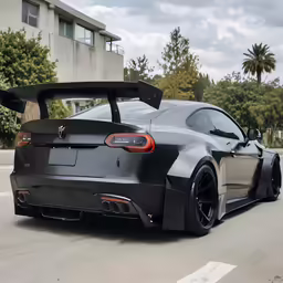 a black sports car is parked on the street