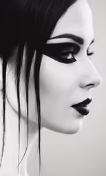 a black and white photo of a woman with her face drawn in black