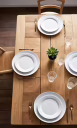 a set table with place setting and a plant in a pot