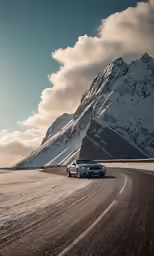 a car traveling on the side of the road in the snow