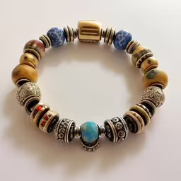 a bracelet made with beads and beads,a bracelet with multiple bead styles and an old fashion clasp