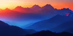 the sun is rising over a group of mountains