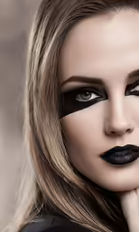 beautiful blond woman with long black lips with long lashes and makeup on