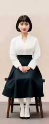 a woman with short hair sitting on a chair