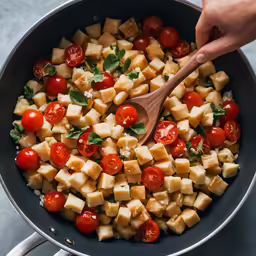 a pan filled with chopped tofu and tomatoes