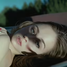 a girl laying down wearing a ring laying on her wrist
