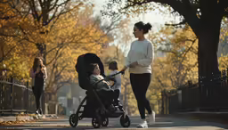 a woman jogging down the street and talking to a child in a stroller