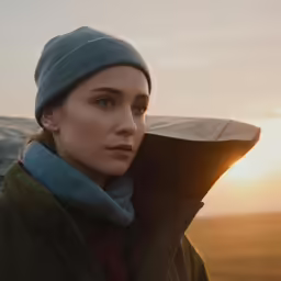 a young woman in the cold looks to her left