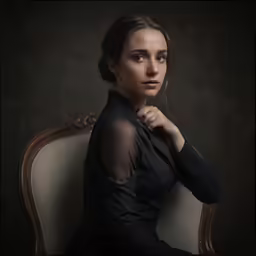 a beautiful young woman sitting in a chair