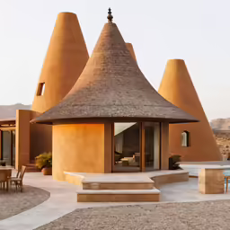 a large thatch roof with steps leading up to the entryway