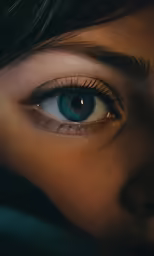 a person with green eyes and black hair