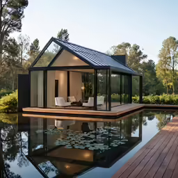 a modern style house sitting on a pool surrounded by trees