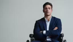 a man in a suit sitting in a wheelchair