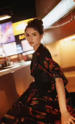 an asian woman sitting in a dimly lit bar