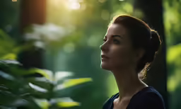 a woman is looking ahead while standing in the forest