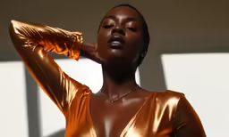 woman wearing orange bodysuit posing with large breast