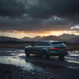 the silver car is driving along the wet road