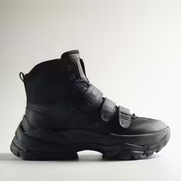 the black ankle high boots with black rubber outs
