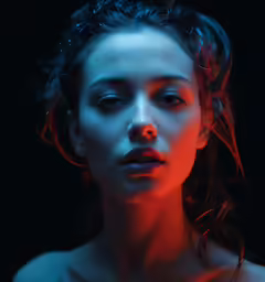 a woman posing with an orange colored light