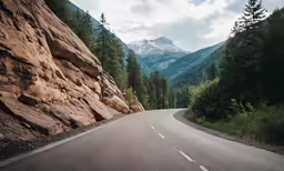 a large mountainous road with a mountain in the background