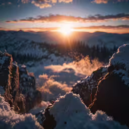 a snowy landscape with trees and clouds at the bottom of it