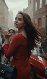 a young lady in a red dress smokes a cigarette