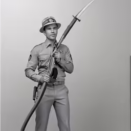 a black and white photo of a man with a gun
