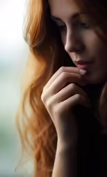 the girl with the long red hair is posing for the camera