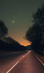 the street lights shine brightly as it passes through the trees