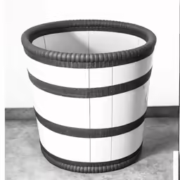 a vase designed to look like a curved striped basket
