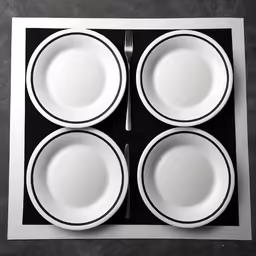 five white plates sitting on top of a black and white mat