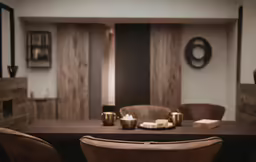 a large wooden table with four brown chairs