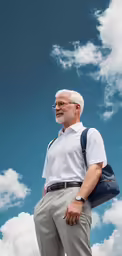 an older man in a white shirt, tan pants and black bag standing under a blue cloudy sky