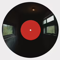 a red object with three windows in the background
