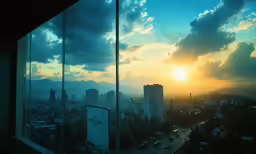 the view from an elevated room at sunset, in a city