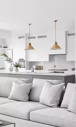 a couch with two lamps hanging over it