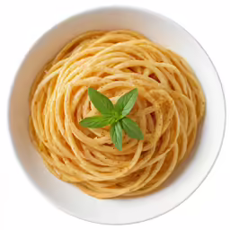 a small fresh basil sits on top of spaghetti in a bowl