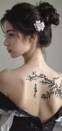 a beautiful girl with some tattoos on her back