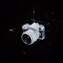 a white camera with its lens up to it