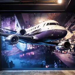 an airplane flying past a large picture of city buildings
