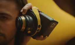 the man is holding his camera up to take a photo