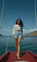 a woman in high - waisted denim shorts standing on a boat