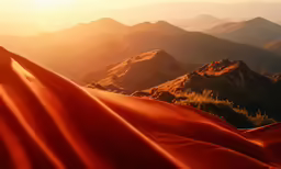 sand dunes with mountains in the background