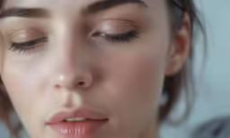 the young woman is wearing long lashes to match her skin tone